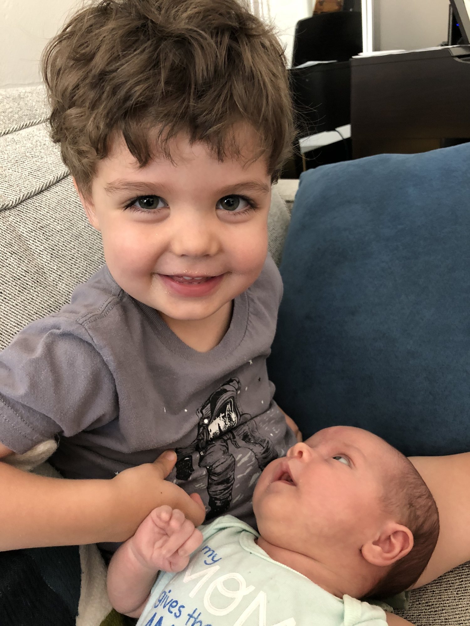 He loves holding "baby sist". Awwww.