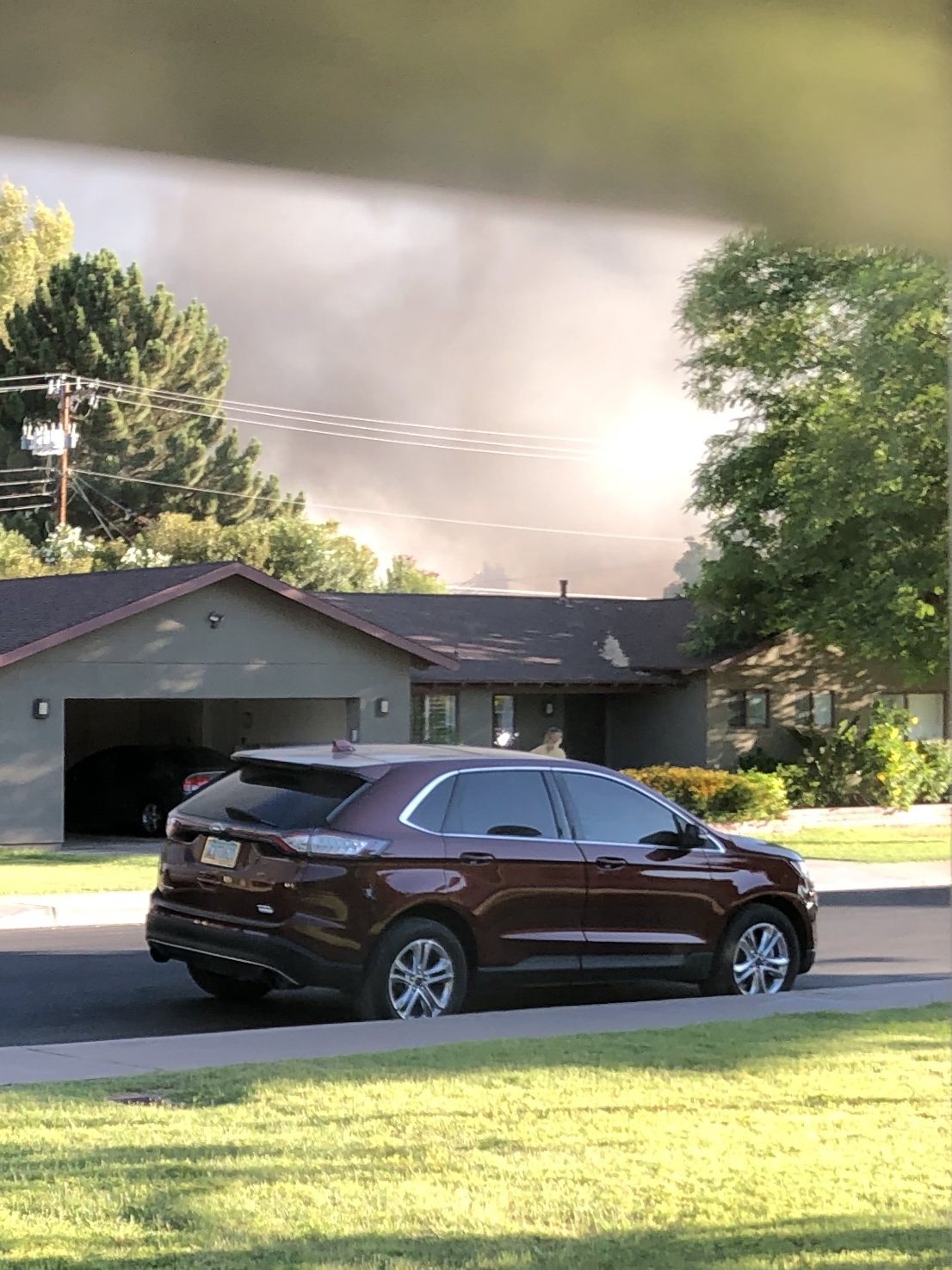 The wrong type of fireworks for the 4th of July. A fire outside of our house :(. You can see the firefighters just above our neighbors' house.