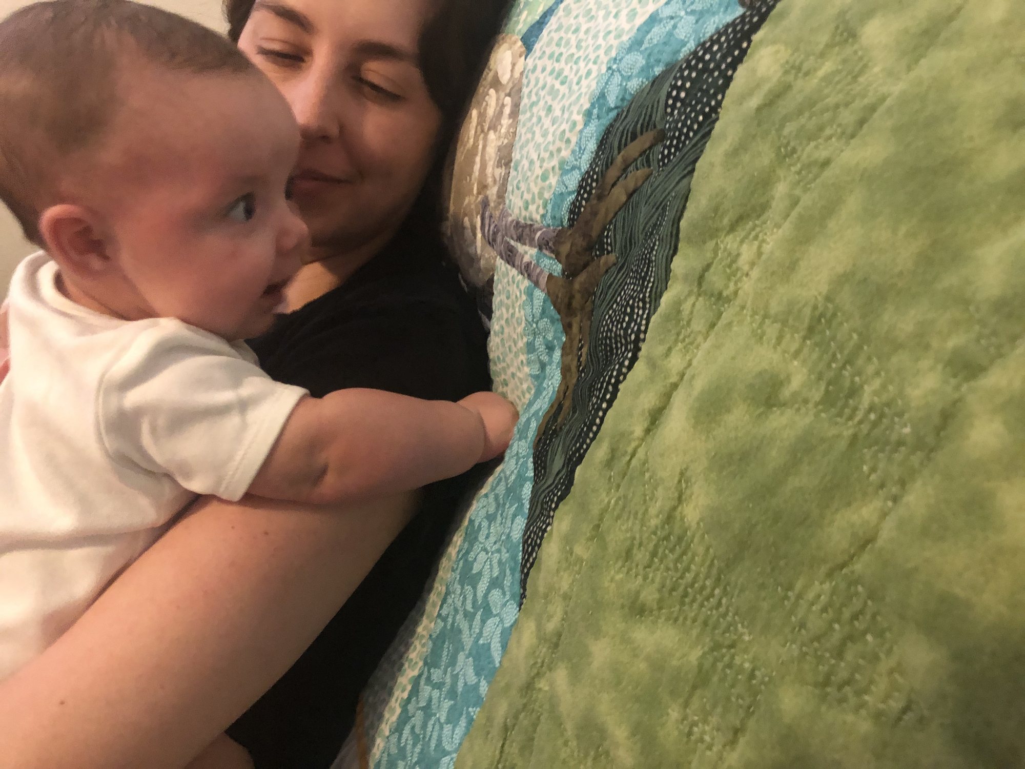 Checking out the quilt that Grandma TT made for her.
