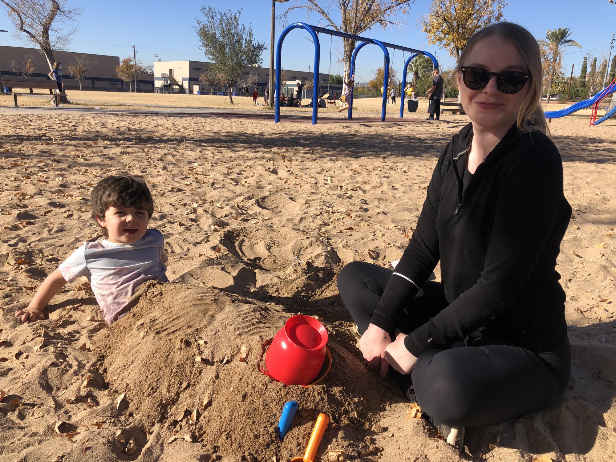 Juliana trying to keep Ben still at the park. Lol.