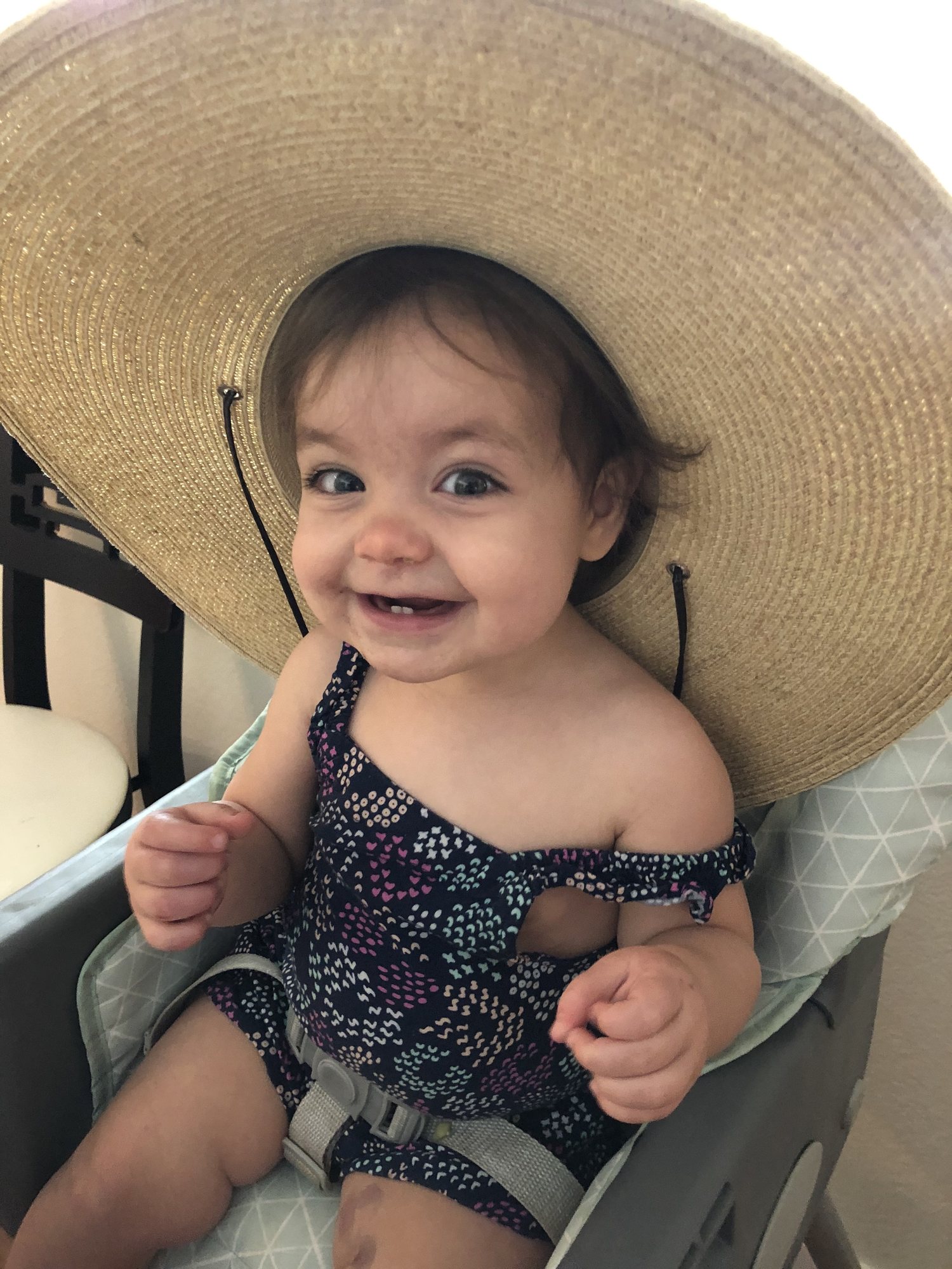 In mama's pool hat (that's cherry juice on her leg!).