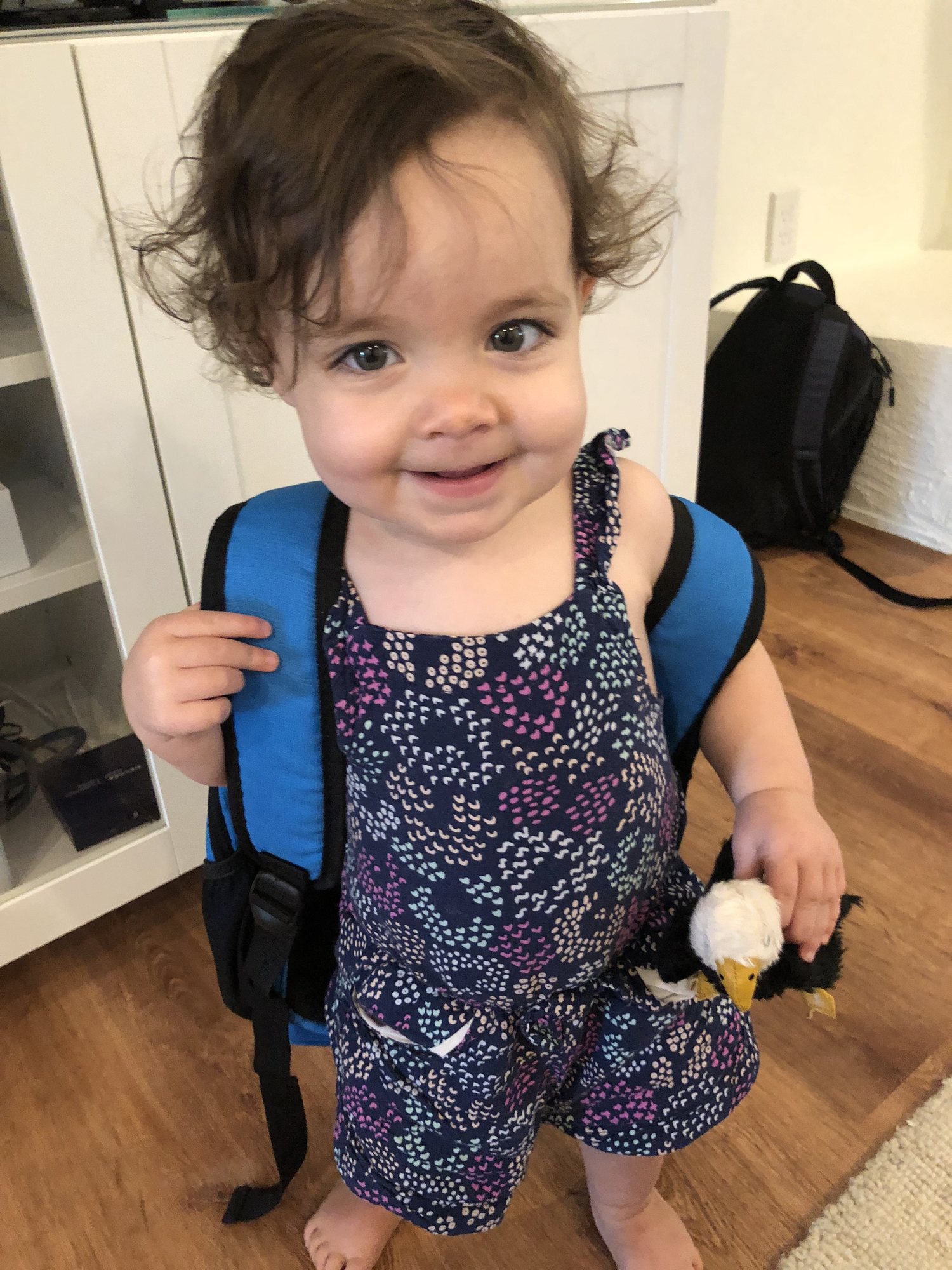 She really wants to do whatever Ben does, including wearing his backpack :)