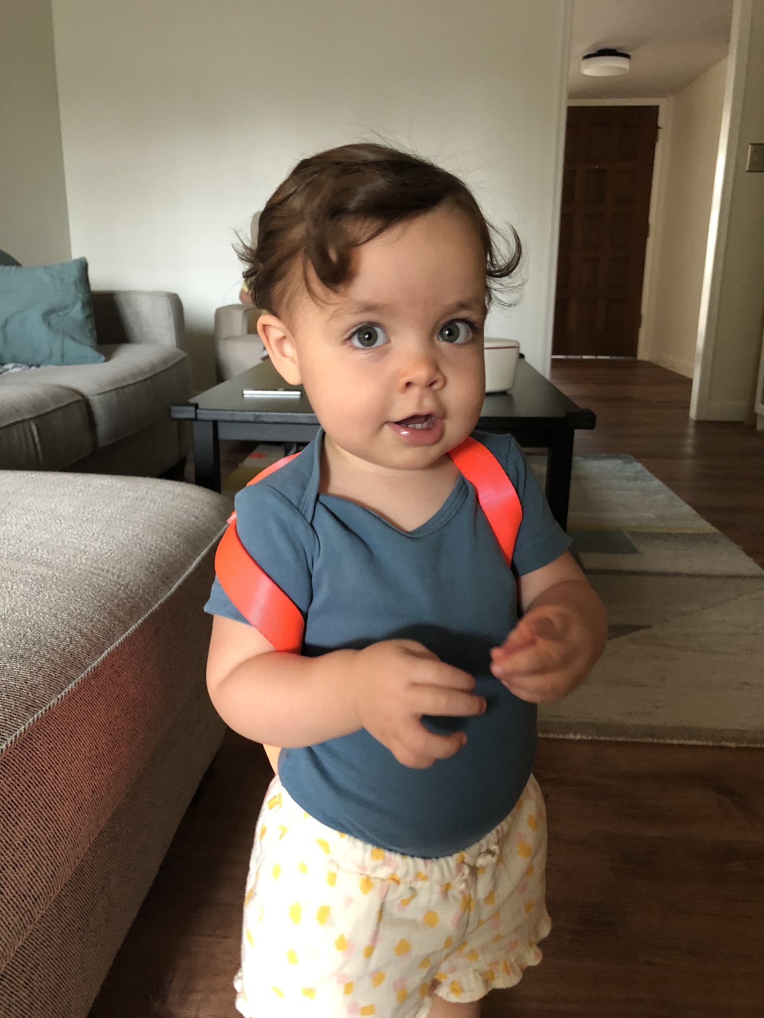 Trying on her backpack. Ben picked the hot pink one for her. She looks like a big girl now!