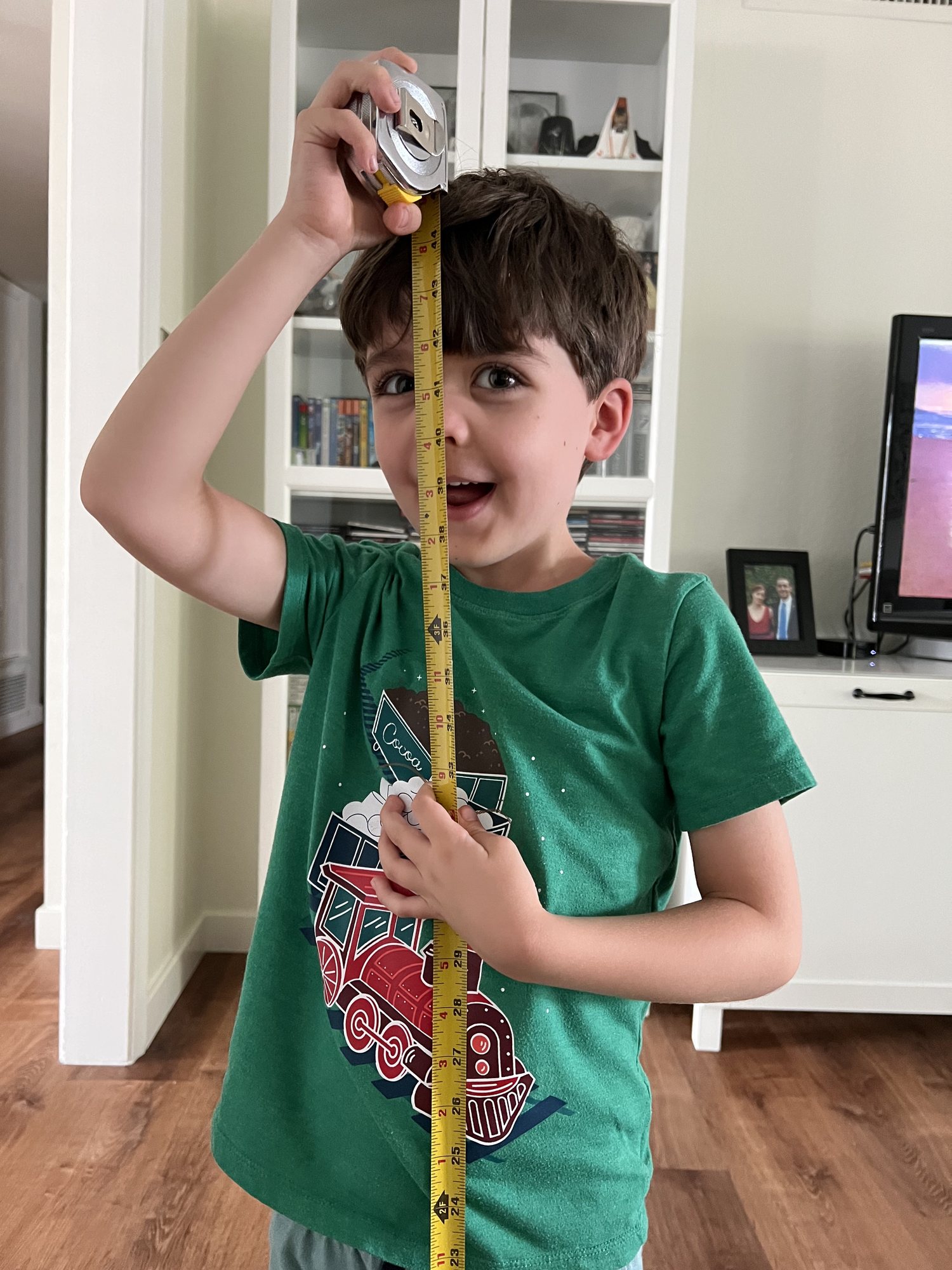 Measuring his height. The nose smash is essential for the most accurate measurement :)