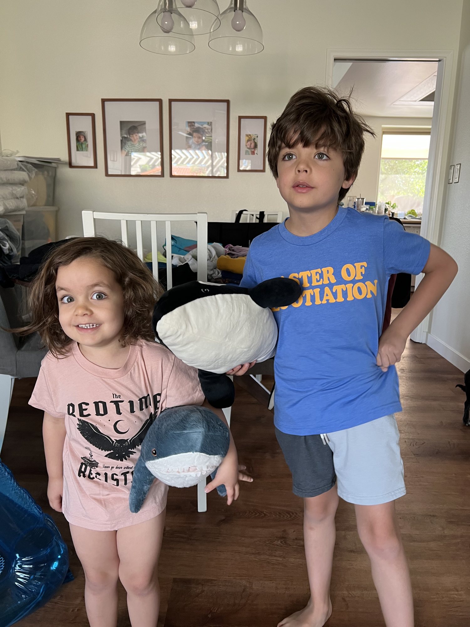Trying on their new shirts... "Bedtime Resistance" and "Master of Negotiation".