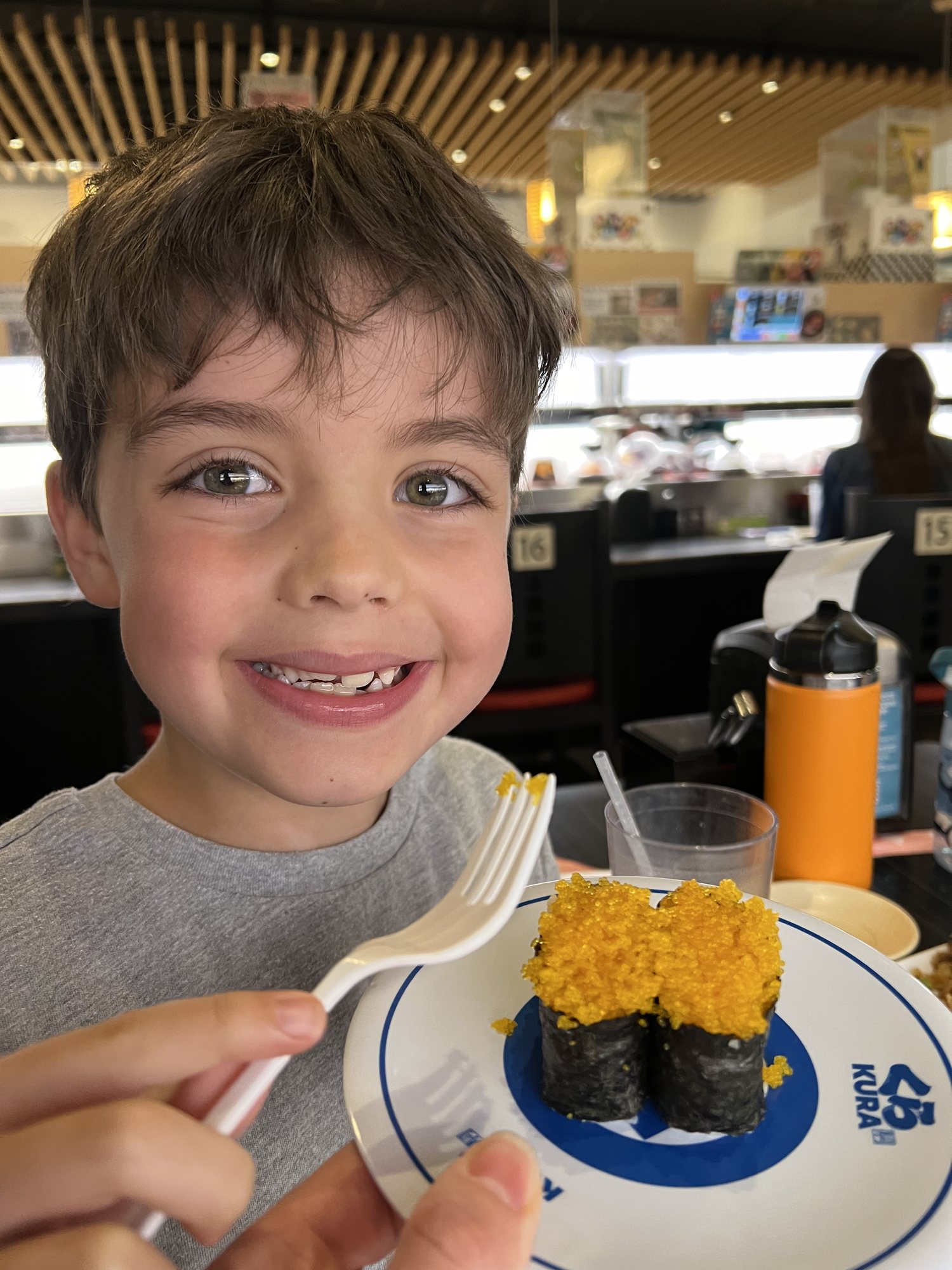 Trying fish roe at the sushi bar. He likes it and keeps asking us for caviar now.