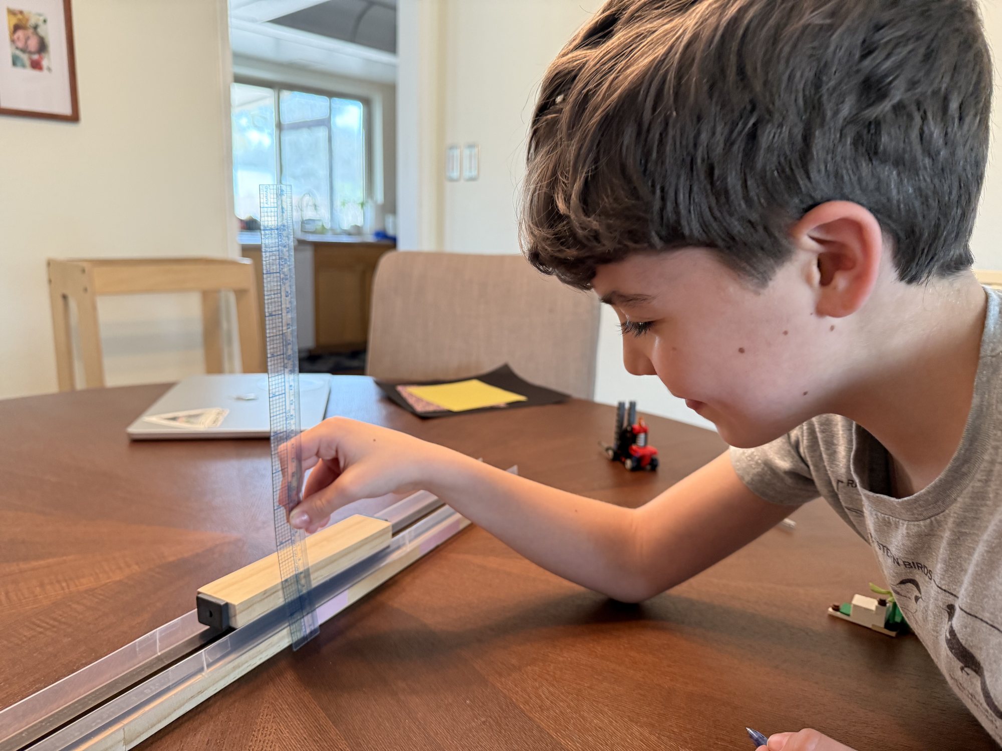 Ben taking measurements of his maglev train.